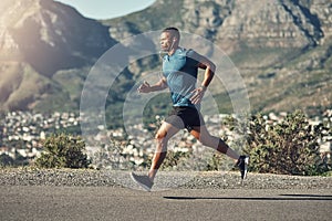 Endure the pain and gain fitness. a young handsome man running outdoors.