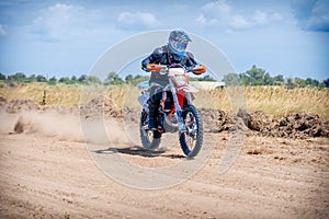 Enduro bike racer riding on a dirt motocross road