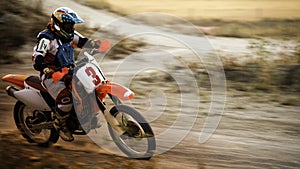 Enduro bike racing along dirt track