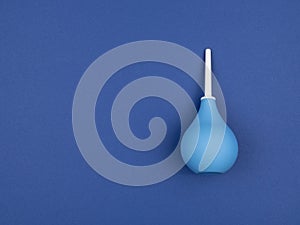 Enema bag on blue background
