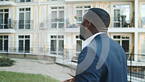 Energetic afro guy making gestures on urban street. Celebration concept