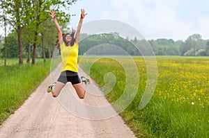 Energetic agile young woman leaping for joy