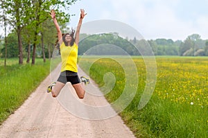 Energetic agile young woman leaping for joy photo