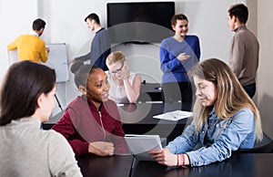 Energetic boys and girls students having conversation at recess