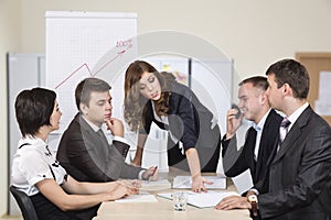 Energetic corporate manager instructs her team