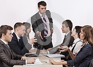 Energetic corporate manager instructs his team