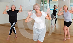 Energetic elderly woman practicing vigorous dance movements