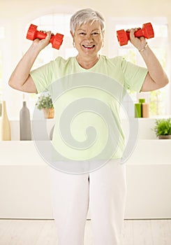 Energetic elderly woman training at home