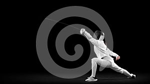 Energetic female fencer in white fencing costume and mask in action, motion isolated on dark background. Sport, youth photo