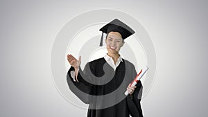 Energetic female graduate walking with diploma and giving motiva