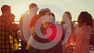 Energetic guy dancing at urban party. Multiracial people partying outdoors.