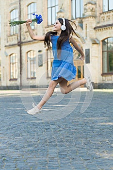Always energetic. Happy girl in energetic jump outdoors. Energetic mood. Fresh vibes. Music and entertainment. Summer