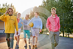 Energetic, healthy teens have fun, talk before playing basketball