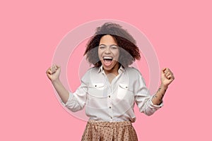 Energetic joyful woman standing hands in fists.