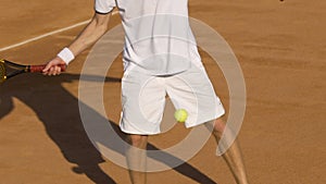 Energetic man returning tennis ball during match, college tournament, slowmotion