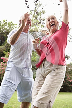 Energetic Senior Couple In Countryside