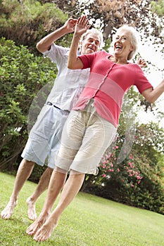 Energetic Senior Couple In Countryside