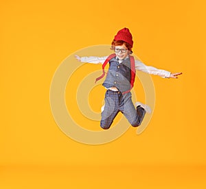 Energetic stylish schoolboy leaping up