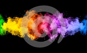 Dynamic explosion of multicolored powder against dark background.