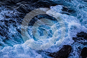 Energetic Waves Crashing down on the rocky beach