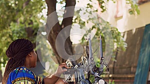 Energetic woman grabbing bicycle wheel