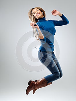 Energetic woman with music player