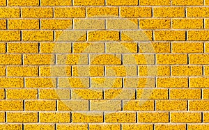 Energetic yellow brick wall as a background image with black vignette.