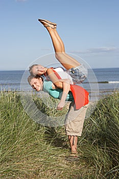Energetic Young Couple Having Fun In Dunes