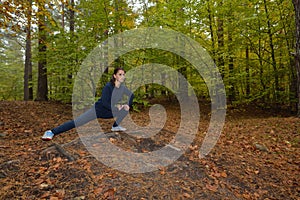Energetic young woman do exercises outdoors in park to keep their bodies in shape. Fitness concept. Body-building theme. Sport mo