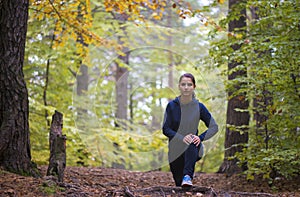 Energetic young woman do exercises outdoors in park to keep their bodies in shape