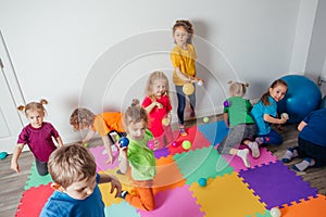 Energetic youngsters throwing away many colorful balls