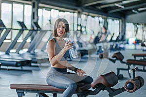 Energizing Break Sports Woman Rehydrates at the Gym