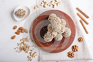 Energy balls cakes with almonds, sesame, cashew, walnuts, dates and germinated wheat, top view, copy space