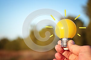 energy and business concept image. Creative idea and innovation. light bulb metaphor in front of the nature