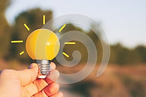 energy and business concept image. Creative idea and innovation. light bulb metaphor in front of the nature