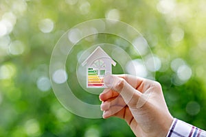 Energy efficient model house in hand .