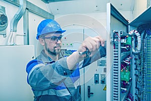 Energy and electricity, electromechanical protective at work with an electric panel, an electrician diagnoses electrical