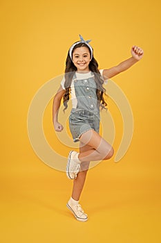 Energy inside. Vacation time. Fashion trend. Little fashionista yellow background. Cute kid fashion girl. Summer fashion