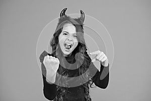 Energy and power. Halloween costumes designed after supernatural figures. Little girl red horns celebrate Halloween