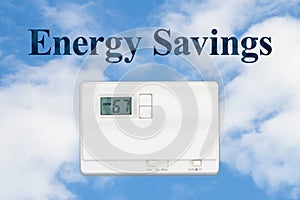 Energy or power savings concept with a home thermostat and sky