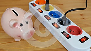 Energy saving concept. Saving money into piggy bank