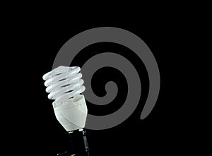 Energy saving lamp isolated on black background.