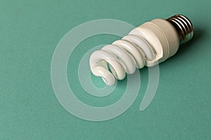 Energy-saving lamp on a light background. The concept of energy