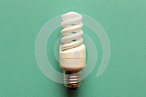 Energy-saving lamp on a light background. The concept of energy