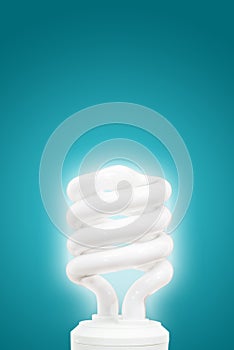 Energy saving light bulb on blue background