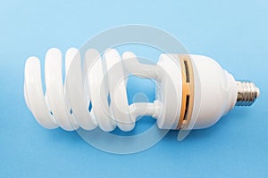 Energy saving light bulb on a blue background