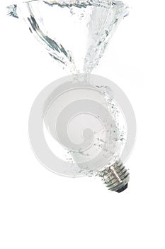 An energy saving light bulb falling into the water