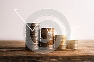 Energy saving light bulb and tree growing on stacks of coins.