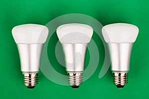 Energy saving wifi light bulb on green background.