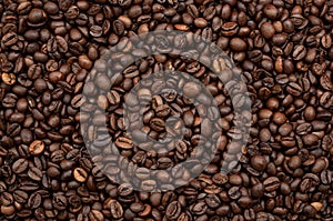 Energy stimulant and smooth java concept with full frame photograph of piled roasting coffee beans backgrounds